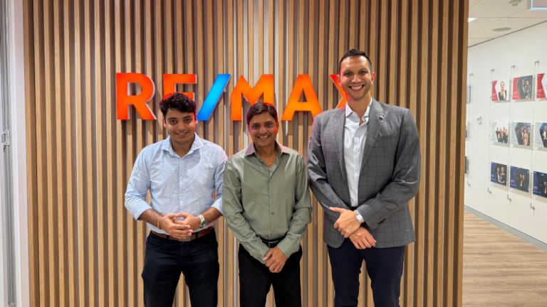 Darsh Patel and Ajay Patel with REMAX Australias Chris Fox. Image ReMAX