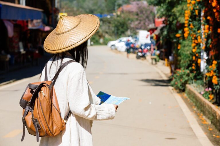 female tourists hand have happy travel map scaled e1736914269121